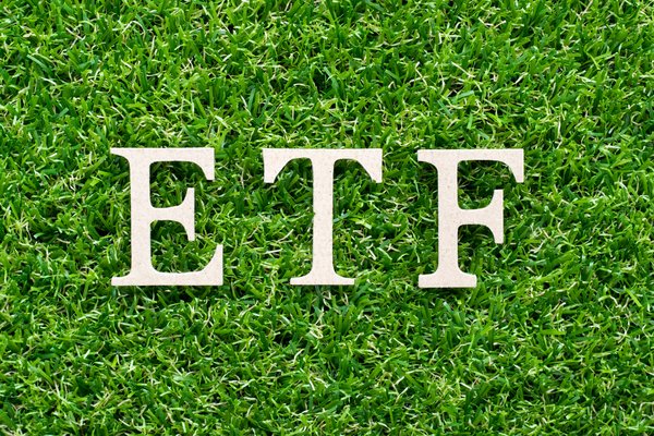 The letters ETF on a bed of green grass.