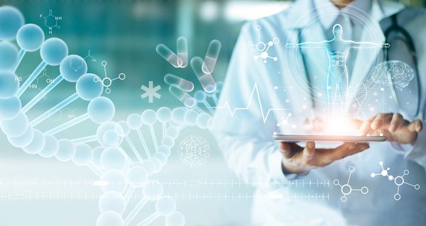 Biotech scientist working on a tablet with bio-related icons projected above it.